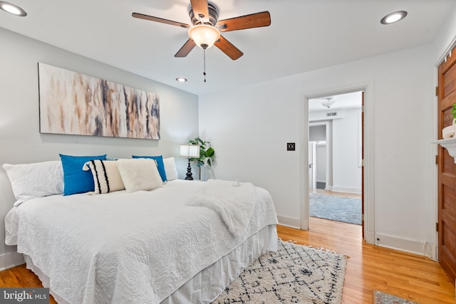 bedroom with ceiling fan and light hardwood / wood-style floors