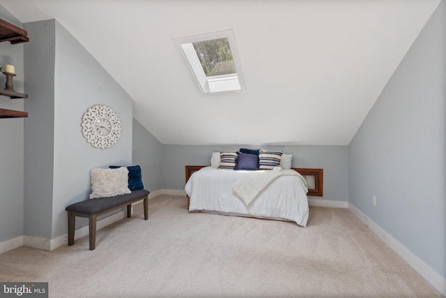 bedroom featuring light colored carpet and lofted ceiling with skylight