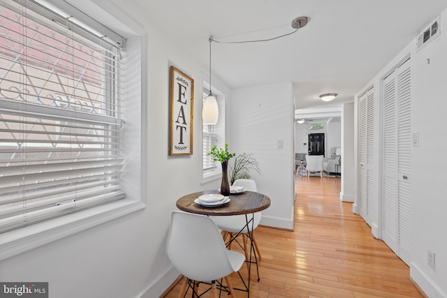 corridor with light hardwood / wood-style floors