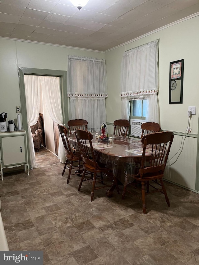 dining area with crown molding and cooling unit