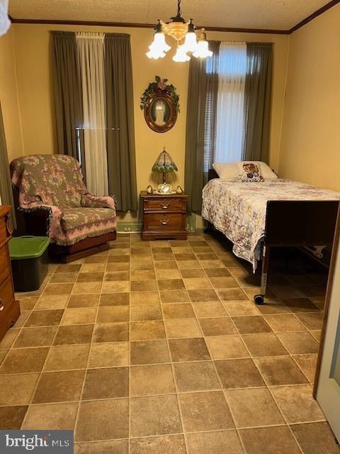 tiled bedroom featuring a chandelier, a textured ceiling, and ornamental molding