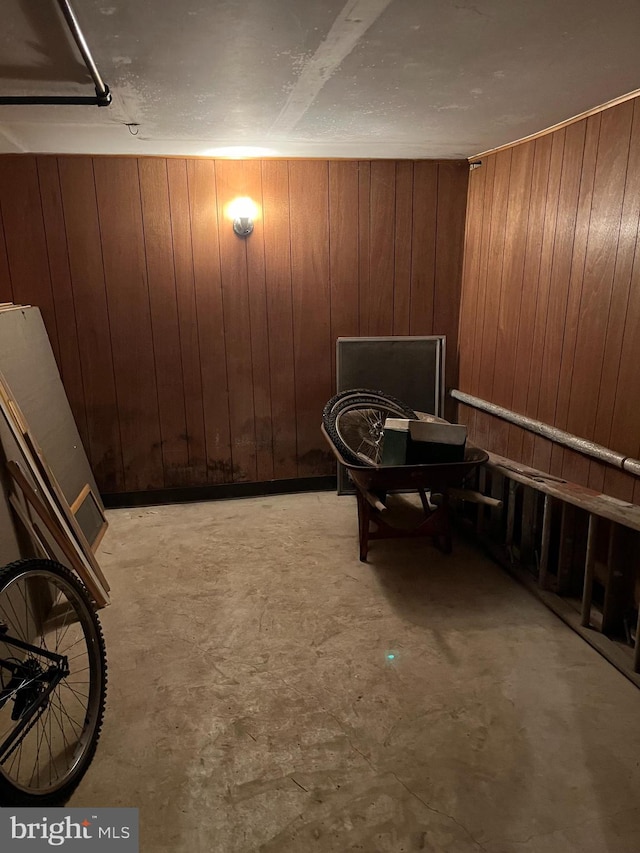 sitting room featuring wooden walls