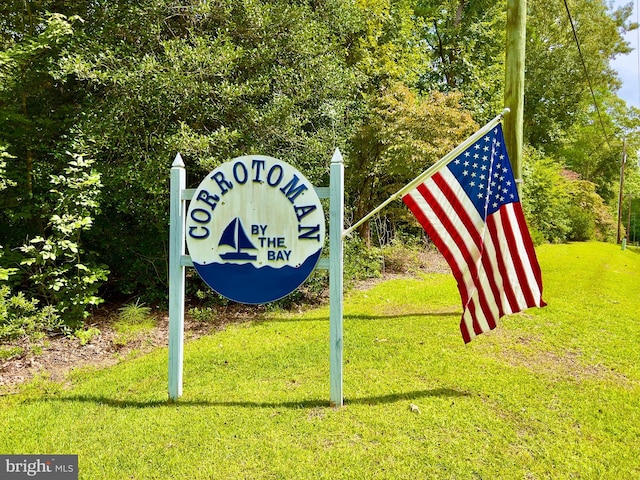 community / neighborhood sign with a lawn