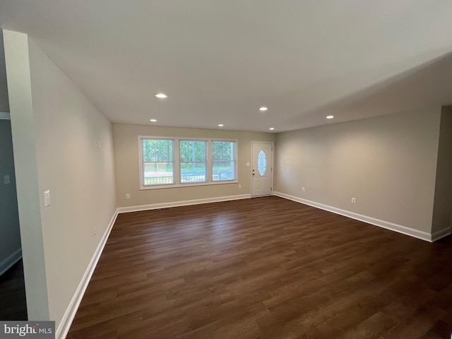 empty room with dark wood-type flooring