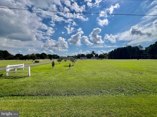 surrounding community featuring a lawn and a rural view