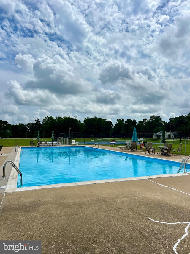 view of swimming pool with a patio