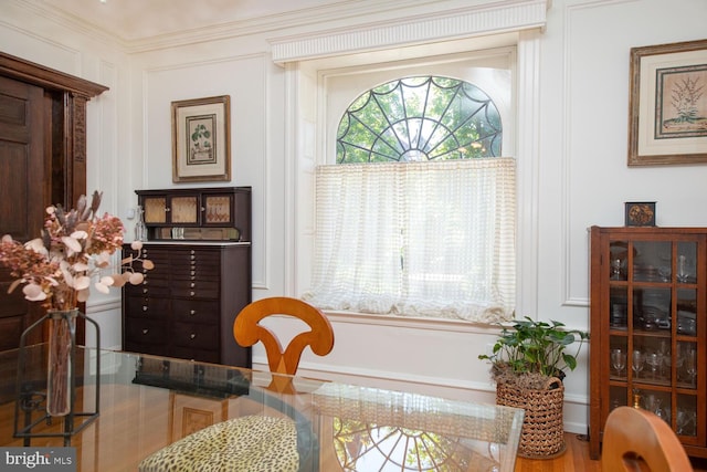 dining area featuring hardwood / wood-style floors and crown molding