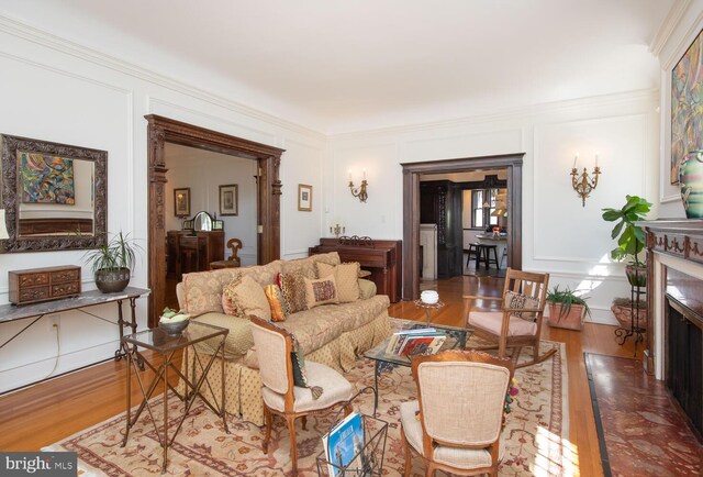 living room featuring crown molding and hardwood / wood-style floors