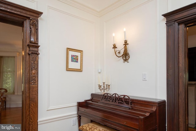 interior space with ornamental molding and hardwood / wood-style flooring