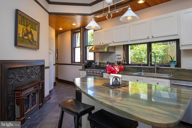 kitchen with white cabinets, wood ceiling, sink, and a healthy amount of sunlight