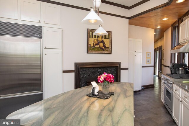 dining room with ornamental molding and wooden ceiling