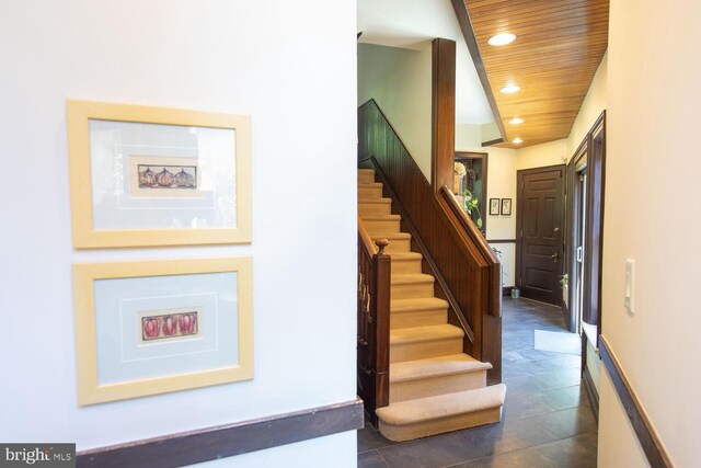 stairs with wood ceiling