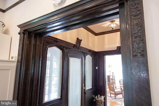 interior details featuring hardwood / wood-style flooring and crown molding