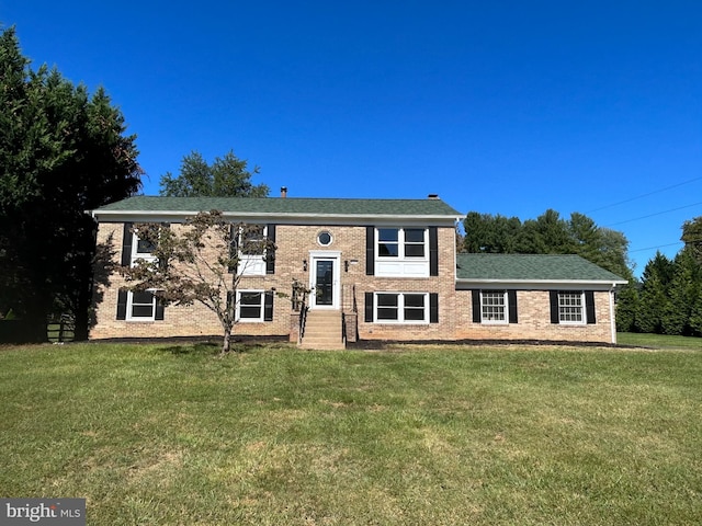 bi-level home with a front lawn