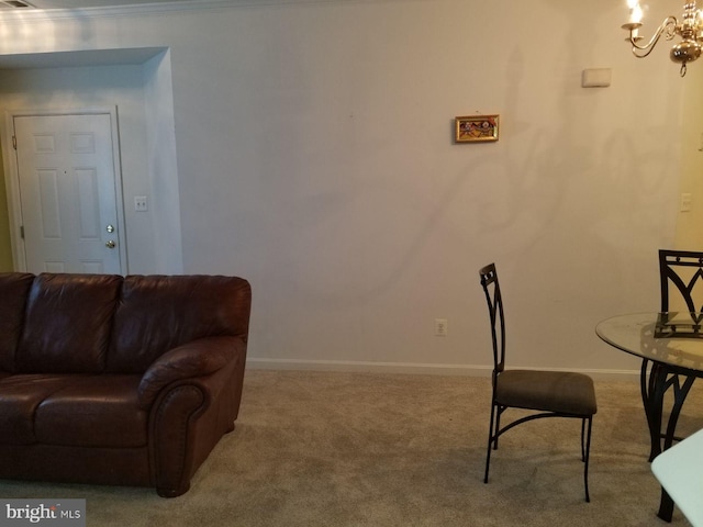 sitting room featuring carpet flooring and an inviting chandelier