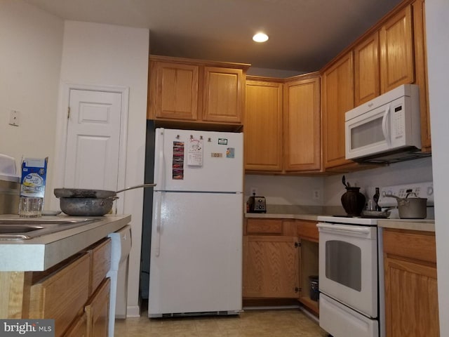 kitchen with sink and white appliances