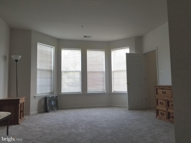 interior space featuring carpet floors, visible vents, and baseboards