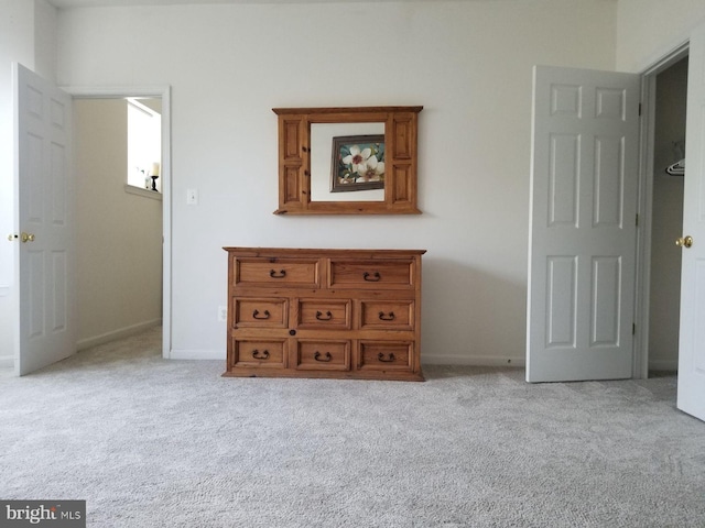 unfurnished bedroom featuring light carpet