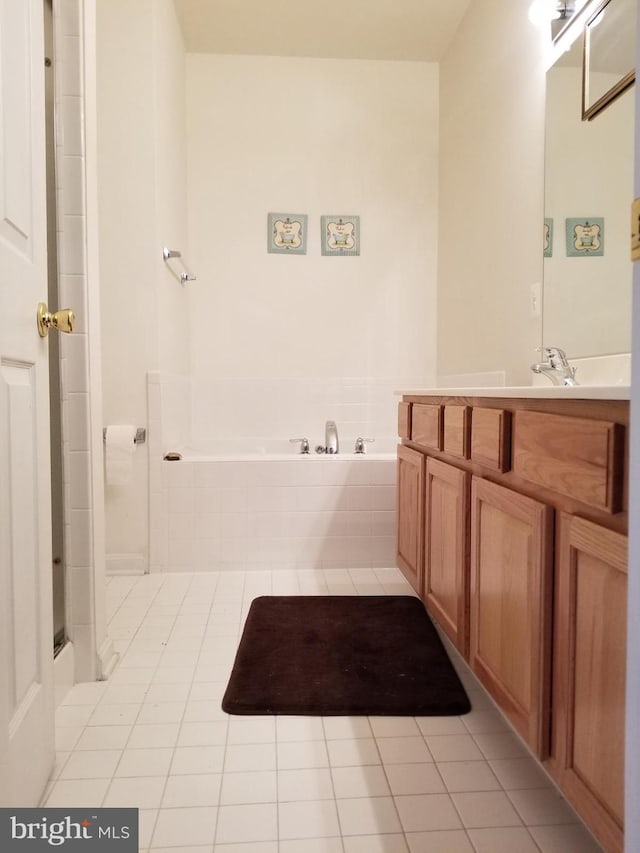 bathroom with vanity, tile patterned floors, and shower with separate bathtub