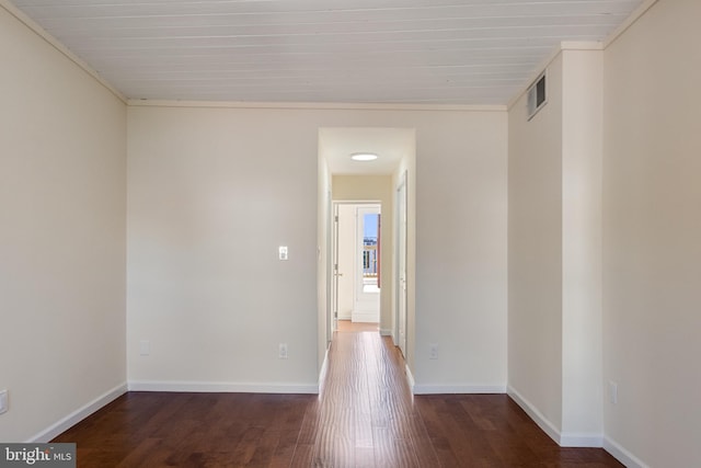 spare room featuring dark hardwood / wood-style floors and ornamental molding