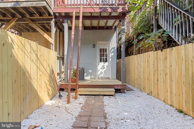 exterior space featuring central air condition unit and a wooden deck