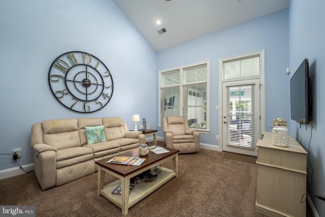 carpeted living area featuring visible vents, high vaulted ceiling, and baseboards