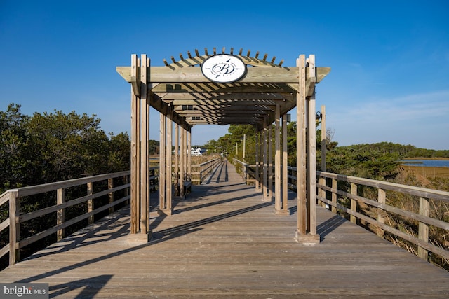 dock area with a pergola and a water view