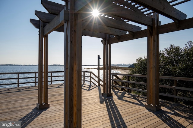 dock area with a water view and a pergola