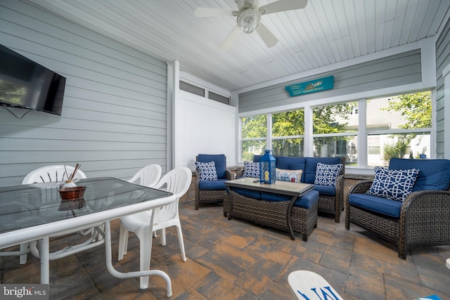 sunroom / solarium featuring ceiling fan