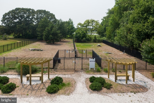 view of community featuring a yard, a pergola, and a playground