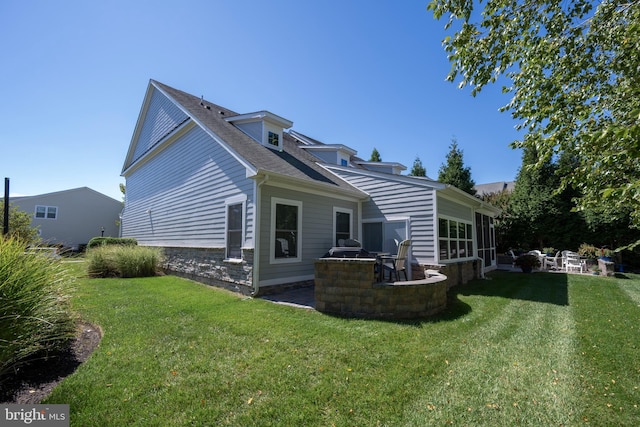 back of property featuring a patio and a yard