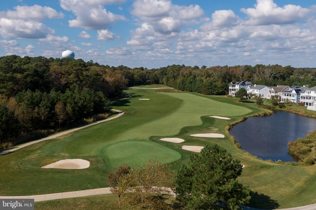 view of community featuring view of golf course and a water view