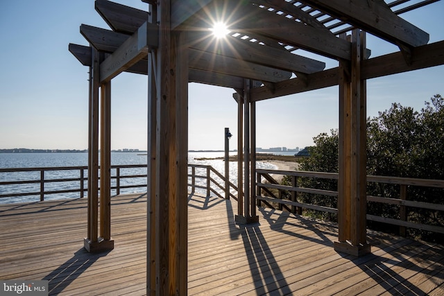 dock area featuring a pergola and a water view