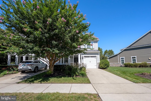 obstructed view of property featuring a garage and a front yard