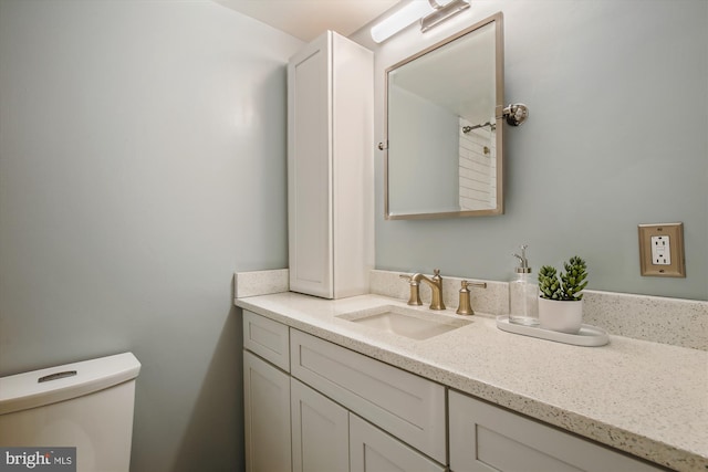 bathroom with toilet and vanity