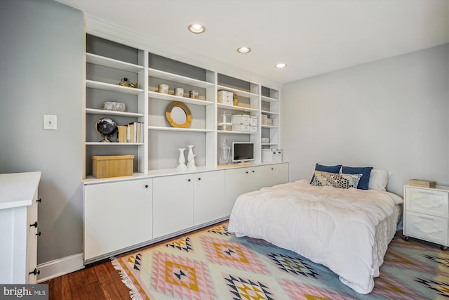 bedroom with dark hardwood / wood-style flooring