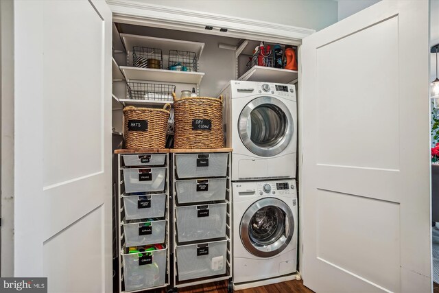 laundry area featuring wood-type flooring and stacked washer and clothes dryer