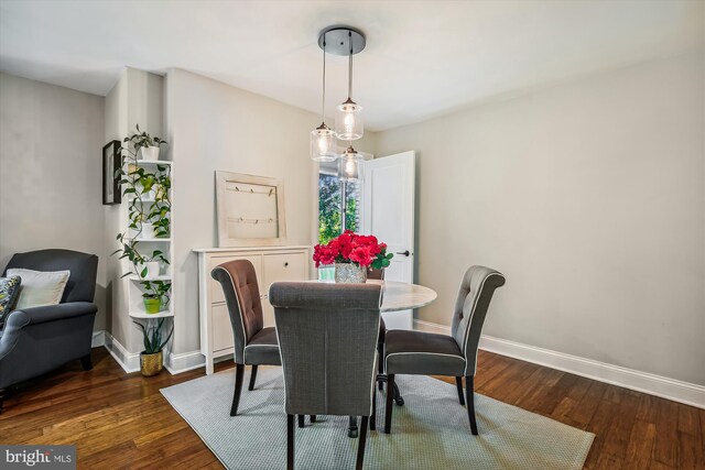 dining space with dark hardwood / wood-style floors