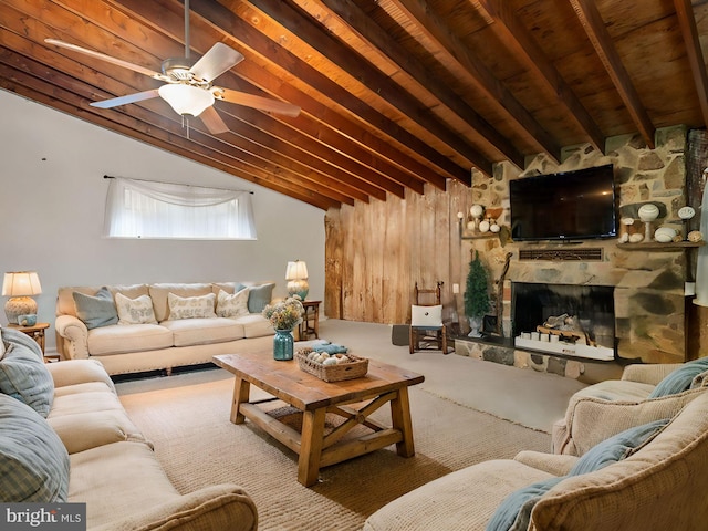 carpeted living room featuring a fireplace, wooden ceiling, wood walls, ceiling fan, and vaulted ceiling with beams