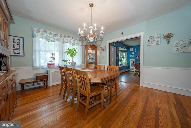 dining room featuring dark hardwood / wood-style floors and an inviting chandelier