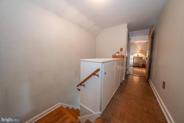 hall featuring lofted ceiling and parquet floors