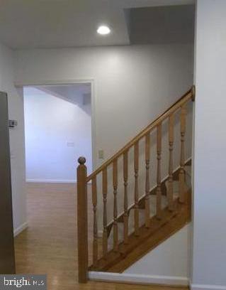 stairway with hardwood / wood-style floors