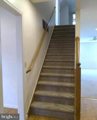 stairs with hardwood / wood-style flooring