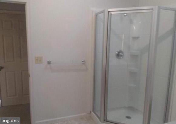 bathroom featuring an enclosed shower