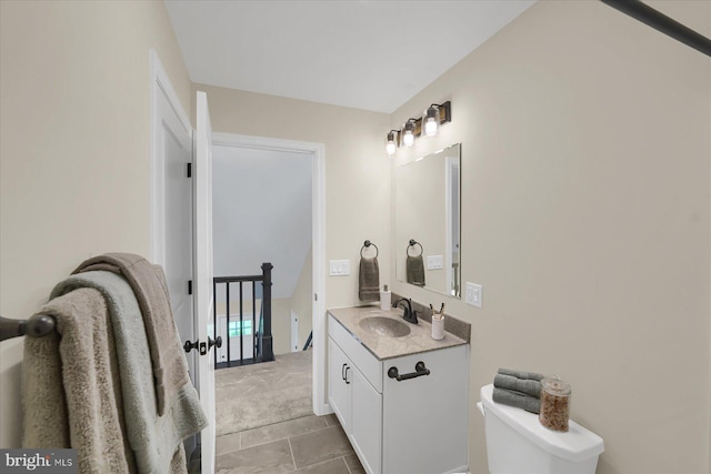 bathroom with toilet and vanity