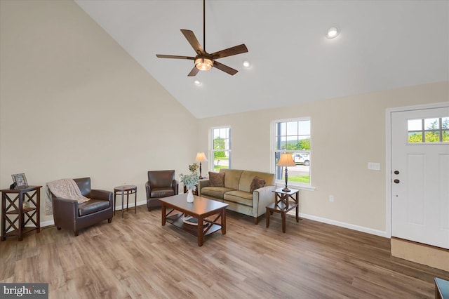 living room with high vaulted ceiling, ceiling fan, and hardwood / wood-style floors