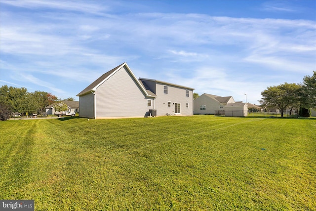 view of side of property with a lawn and central AC unit