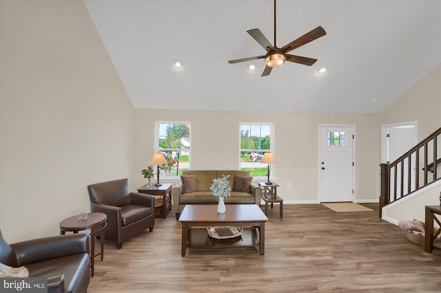 living room with ceiling fan, hardwood / wood-style flooring, and high vaulted ceiling