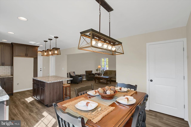 dining room with dark wood-style floors and recessed lighting