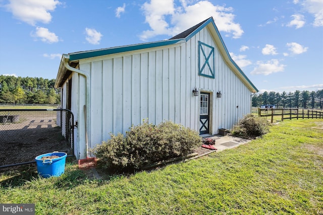 view of outdoor structure featuring a lawn